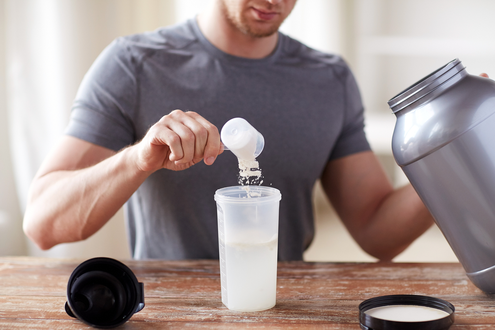 Stock image of man making protein shake